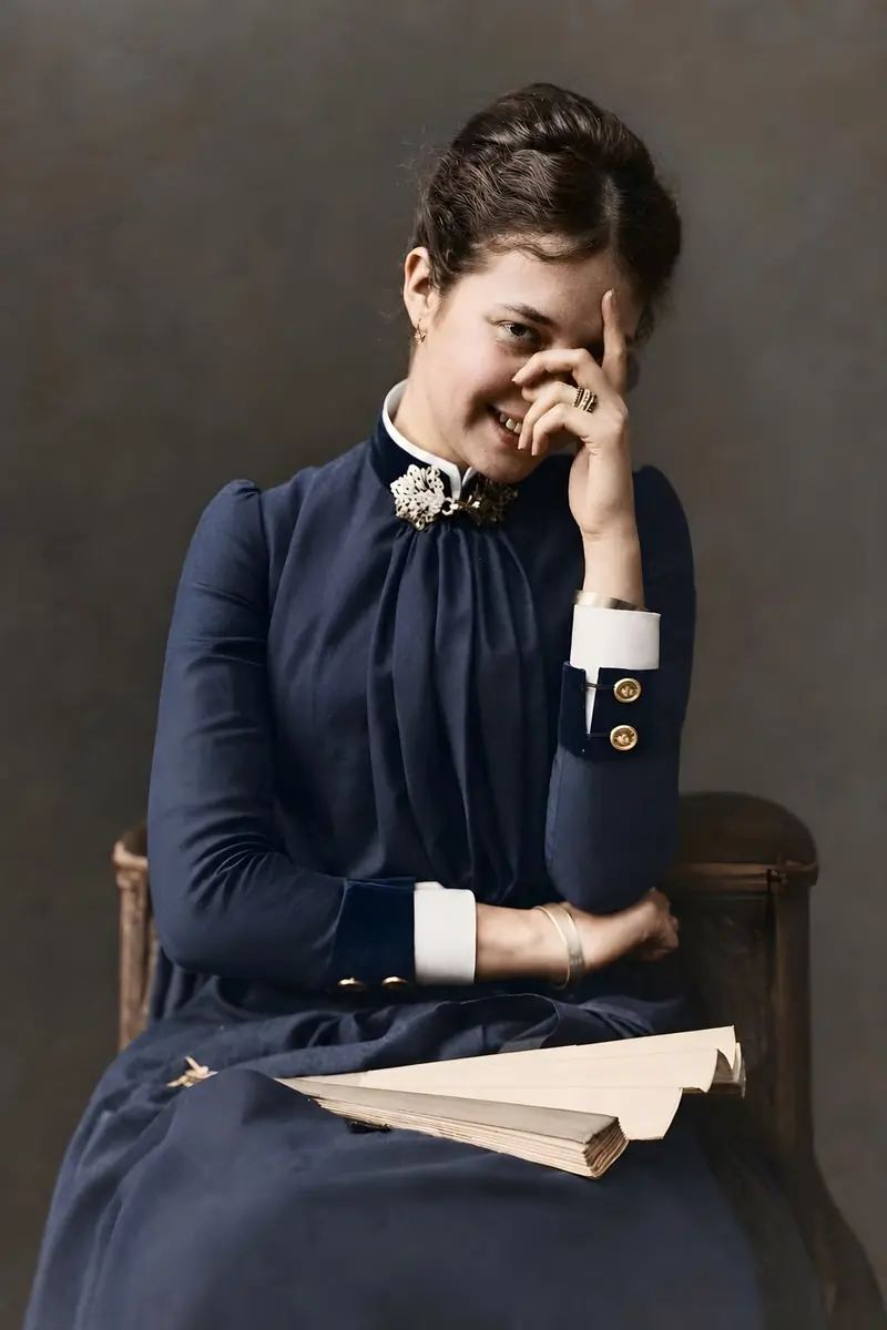 Preserved photographic-style portrait of a seated woman in dark historic clothing